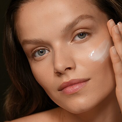 photo of woman applying skincare