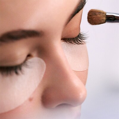 photo of woman getting wedding skincare and makeup done